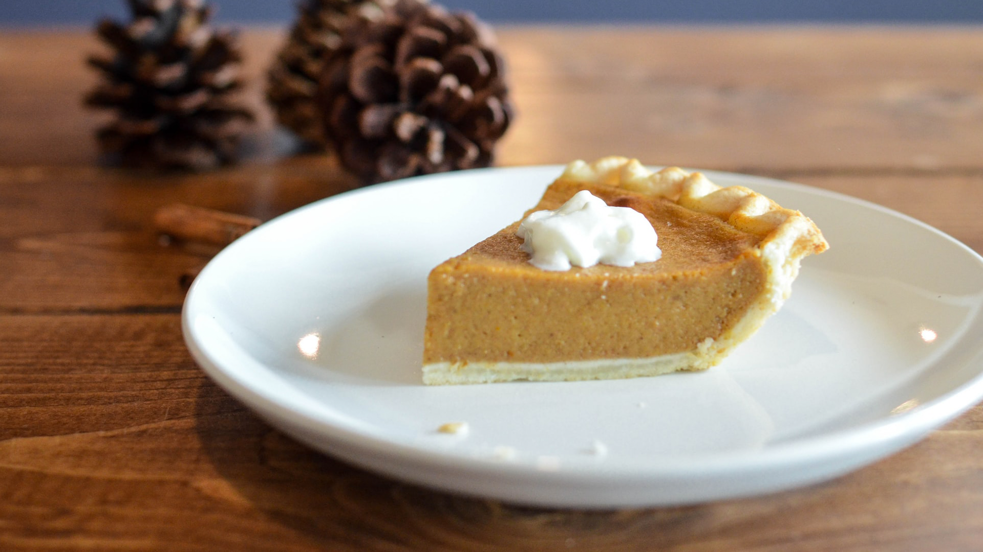 slice of pumpkin pie on white plate