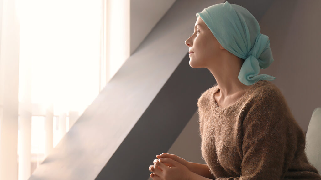 woman with cancer looking out window